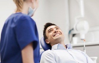 a patient talking to a dentist about tooth-replacement options 