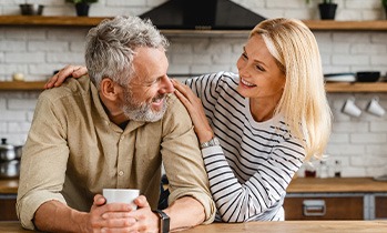 Happy mature couple standing in their kitchen