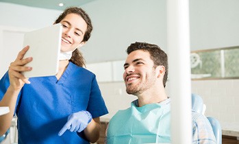 Dentist showing patient image on tablet