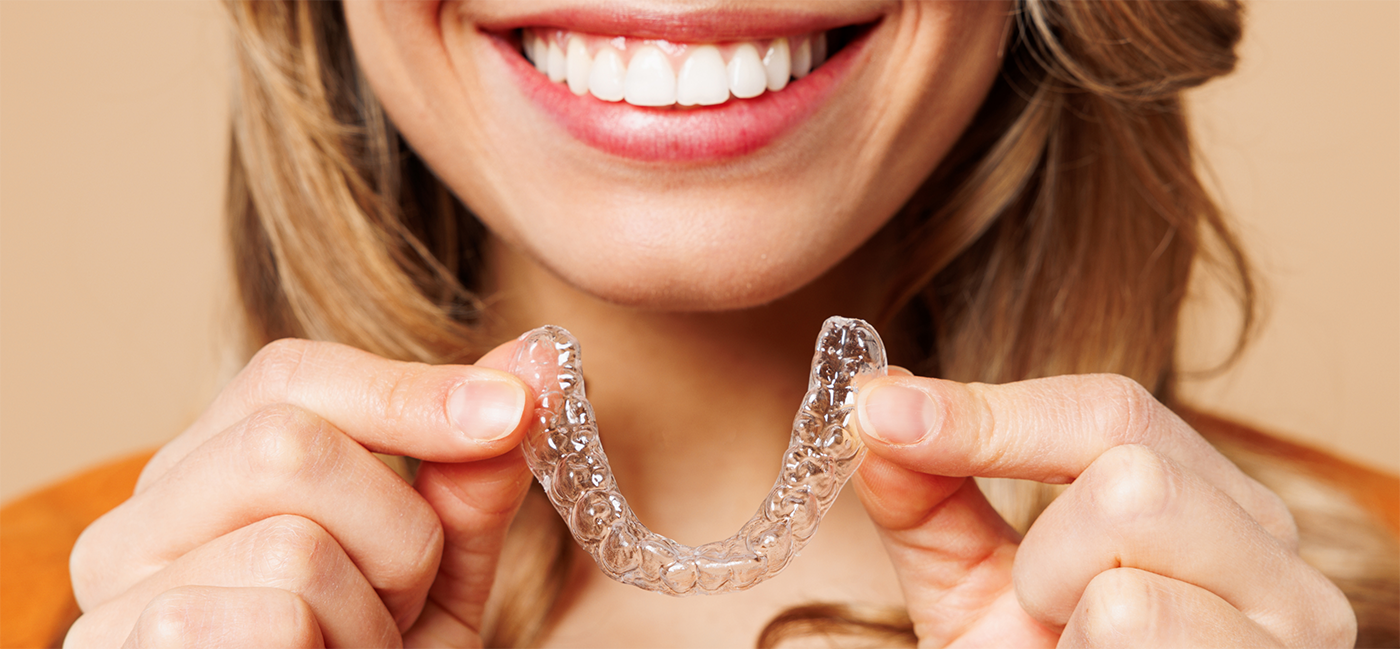 Close up of woman holding a CandidPro clear aligner in Little Rock