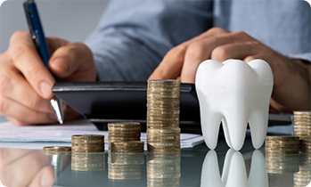 Tooth and stacks of coins