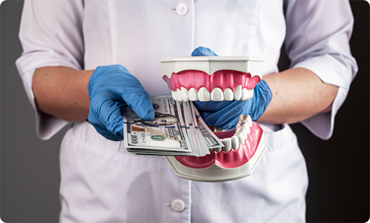 Man holding denture and wad of cash