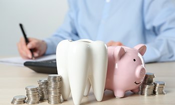 Coins next to a piggy bank