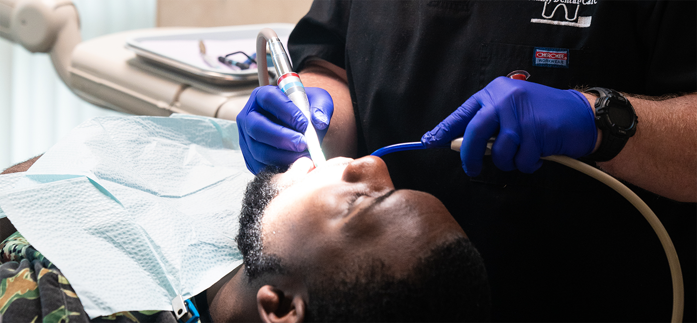 Man receiving treatment from dentist