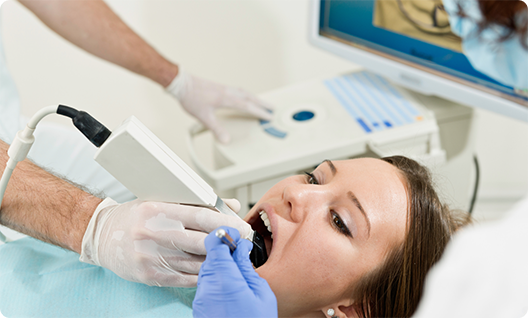 Female dental patient having her mouth scanned