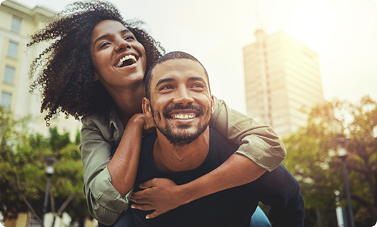 Man giving a woman a piggyback ride