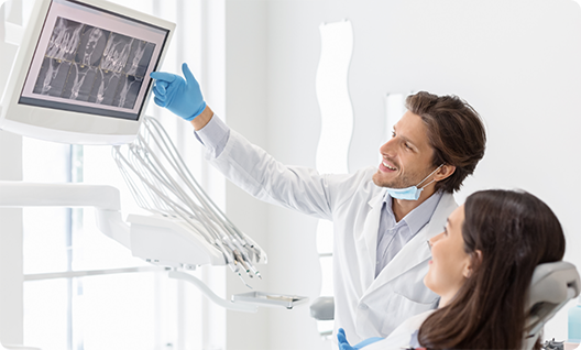 Dentist showing female patient an X ray