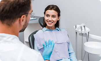 Dentist talking to female patient