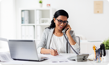 Woman talking on phone and writing something down