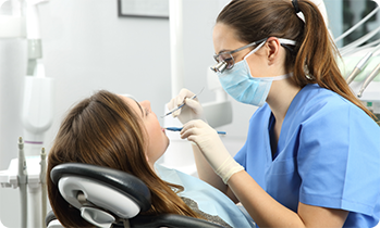 Female dentist performing checkup