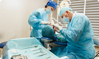 Angled shot of dentists during dental implant placement