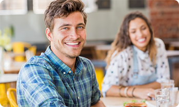 Man and woman smiling at table