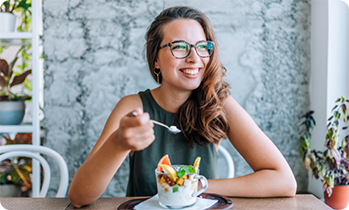 Woman eating fruit salad