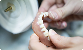 Teeth being placed in base of denture