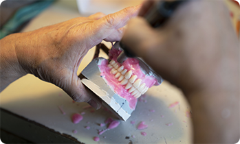 Close up of technician creating dentures