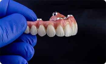 Holding a denture meant for dental implants