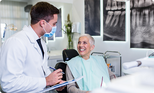 Woman smiling and speaking to dentist