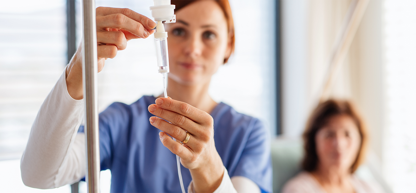 Female dentist adjusting IV drip for IV sedation in Little Rock