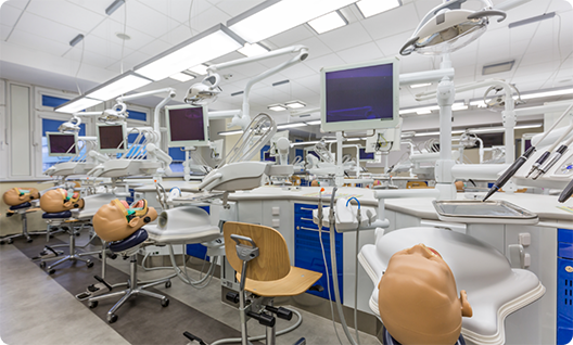 Dental classroom with dummies of patients set up for treatment