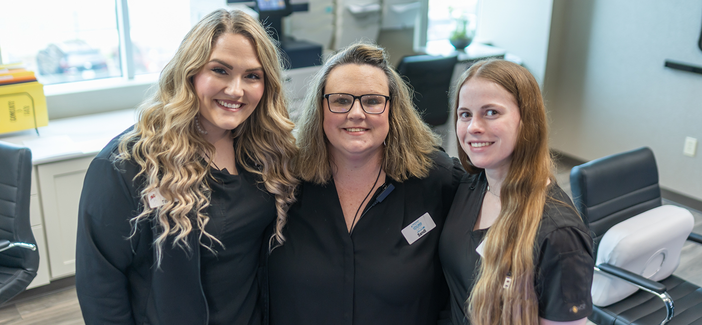 Three women in Little Rock dental office smiling