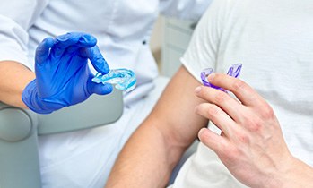 Dentist offers mouthguards to patient