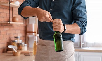 Man opens bottle with opener