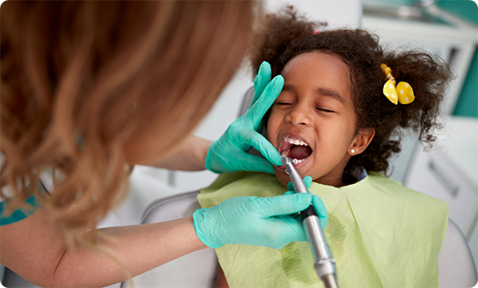 Little girl having her teeth cleaned