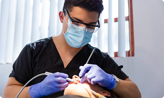 Dentist giving patient an oral cancer screening