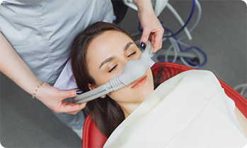 Female patient with eyes closed having nasal mask placed