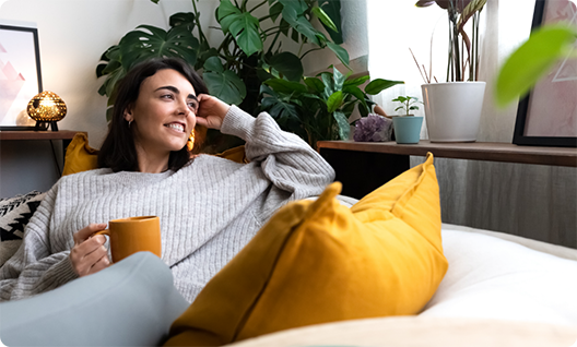 Woman with a mug sitting on a couch