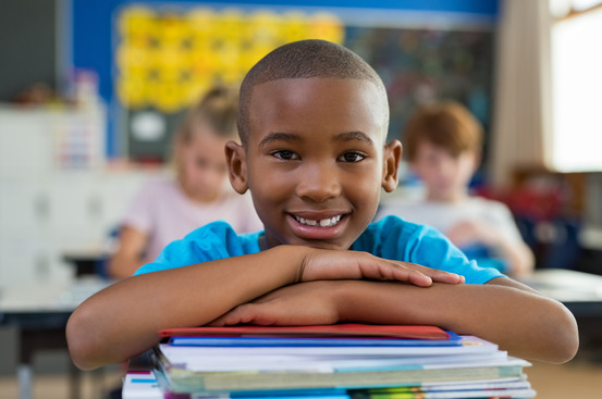 young child smiling while in school